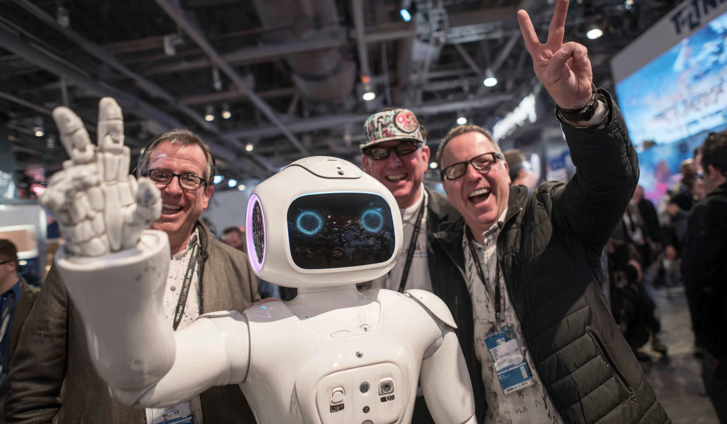 Visitors alongside a humanoid robot at a technology event